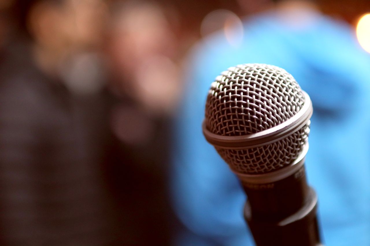 Focused microphone ready for performance, capturing crisp sound indoors.